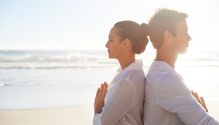 Couple Meditating on the Beach