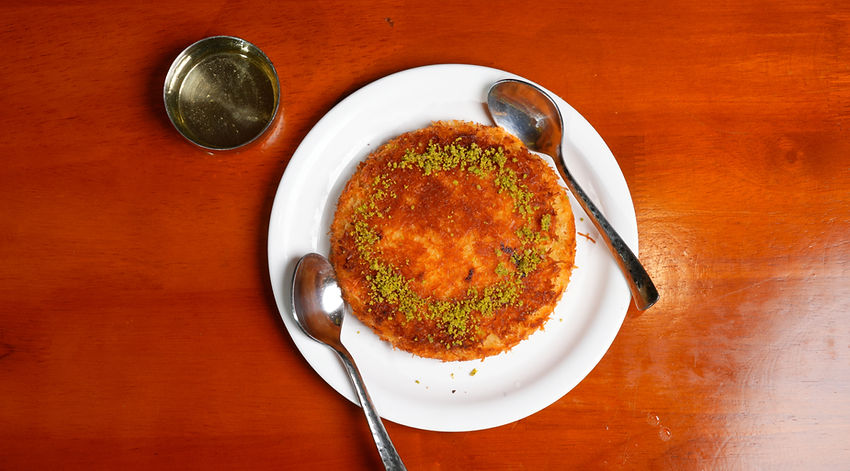 Authentic Arabian dessert with crispy layers and pistachio topping