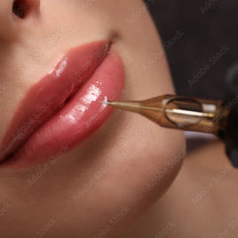 Close up of pink lips getting permanent make-up.