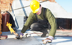 Roofer insulating the roof