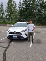 view of a man standing in front of a car