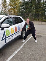 woman besides a car of driving school