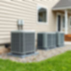 Durable, outdoor-mounted air conditioning unit serviced by Sharony HVAC Services, securely affixed to a residential building for effective cooling.