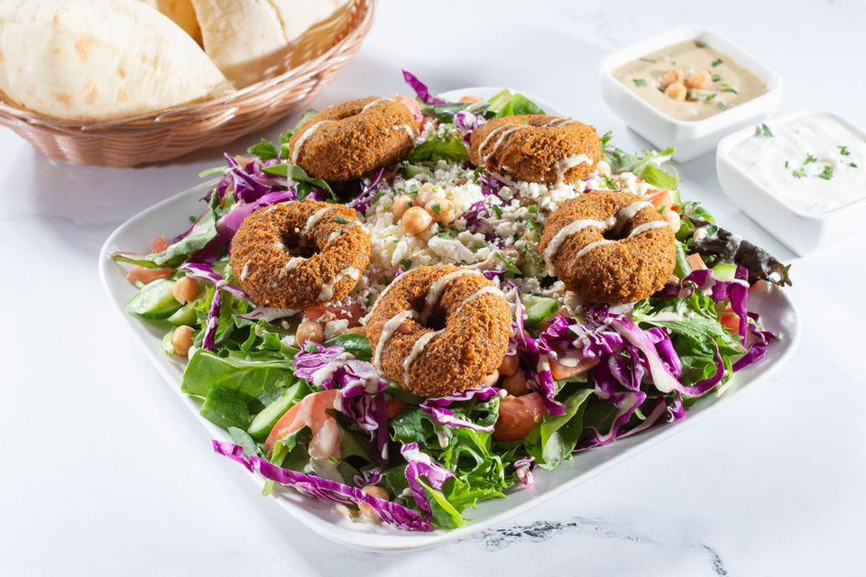 Vegetarian Bowl: Falafel, Lettuce, Cabbage, Feta Cheese, Chickpea, Cucumber Tomato, Vegan Tahini Sauce.