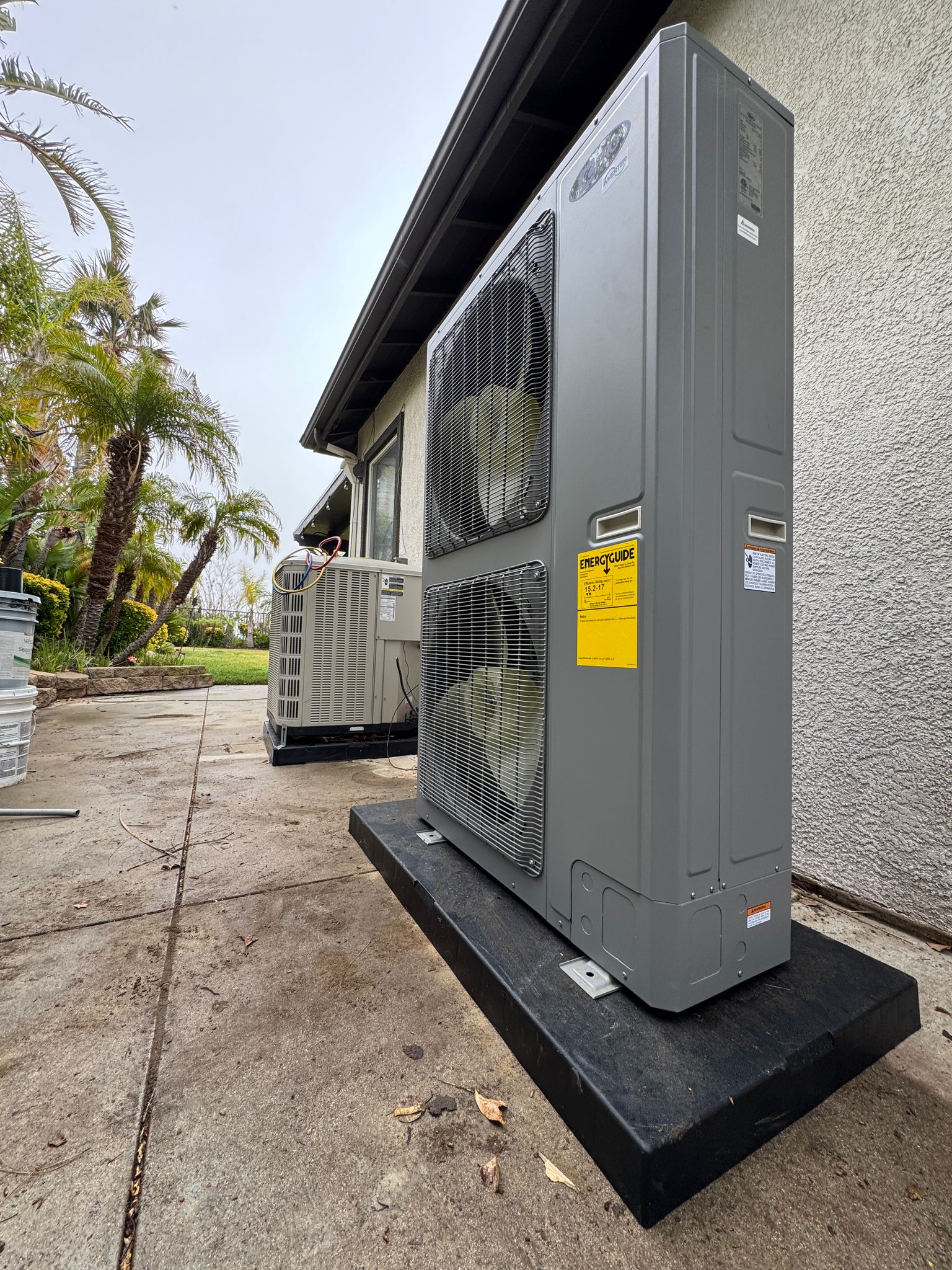AyrSmith HVAC technician installing a brand-new heating and cooling system in a residential property
