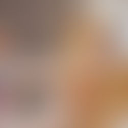 A veterinarian wearing a face mask brushes a golden dog’s teeth with a yellow toothbrush while gently holding the dog’s head during a dental checkup.