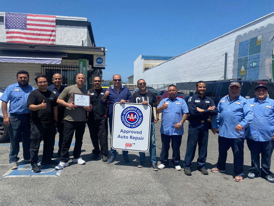 A-One Auto Center's team of technicians, proudly displaying AAA Approved Auto Repair certification.