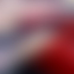 Gloved hands cleaning and disinfecting red leather aircraft seats with a spray bottle and cloth to ensure passenger hygiene and safety.