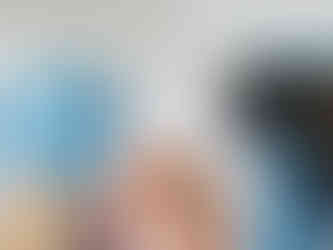 Gloved hands gently swabbing a dog’s nose with a sterile cotton swab for diagnostic testing.