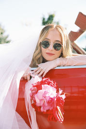 35mm film photo by las vegas elopement photographer brazen honey films. couple takes pictures with cherry red vintage convertible