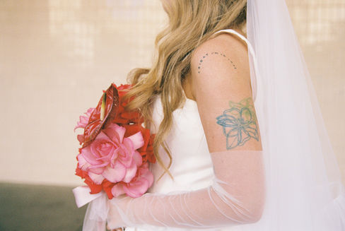 35mm film photo by las vegas elopement photographer brazen honey films. couple takes pictures in downtown las vegas with neon lights and vintage vibes.