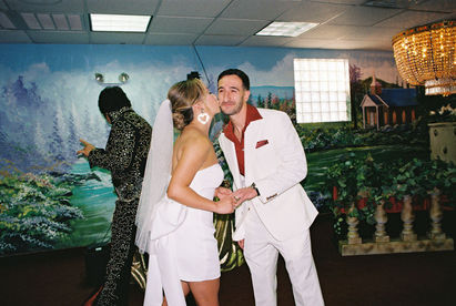 Kitsch elopement at the little white wedding chapel in las vegas shot on 35mm film. Neon lights wedding portraits by wedding photographers brazen honey films