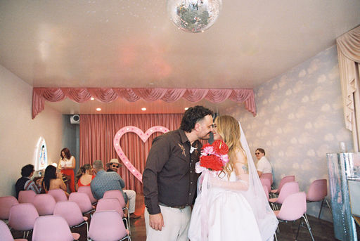 35mm film photo by las vegas elopement photographer brazen honey films. couple gets married at sure thing chapel with pink vintage vibes.
