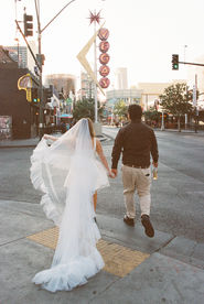 35mm film photo by las vegas elopement photographer brazen honey films. couple takes pictures in downtown las vegas with neon lights and vintage vibes.