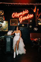 bride and groom pose for photos at a dive bar in las vegas captured by las vegas elopement photographer brazen honey films