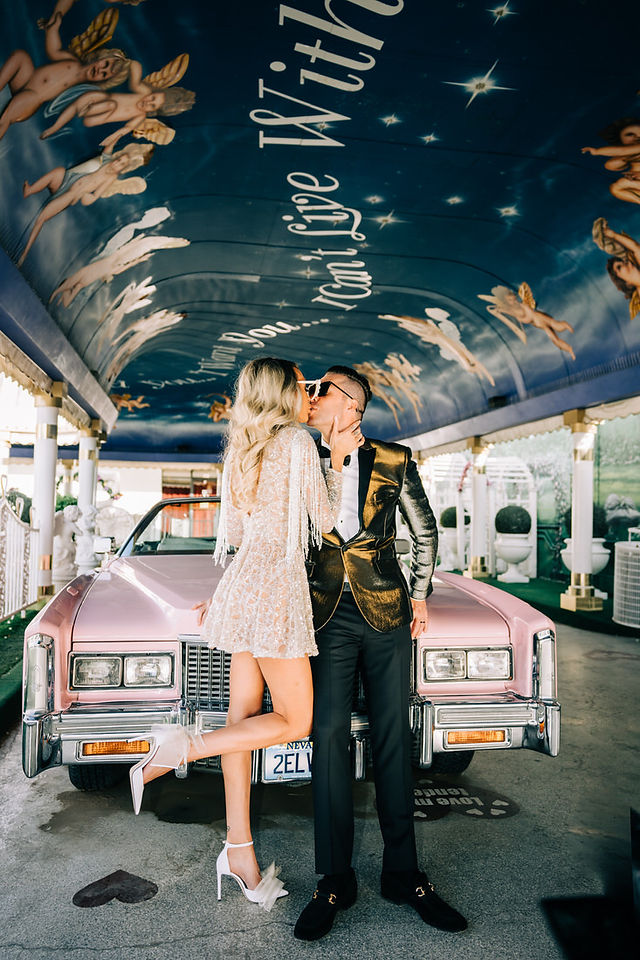 Glitter wedding dress fashion, bride and groom take photos in the tunnel of love at the little white wedding chapel captured by Las Vegas elopement photographer brazen honey films 