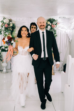 bride and groom recite wedding vows at the little white wedding chapel in las vegas. elvis wedding officiant captured by las vegas elopement photographer brazen honey films