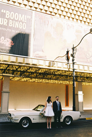 Couples poses for wedding photos in downtown las vegas, nevada. captured by las vegas elopement photographer brazen honey films at the plaza downtown on 35mm film photography