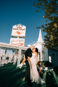 Couple celebrates their wedding outside the little white wedding chapel on fremont street. captured by las vegas elopement photographer brazen honey films