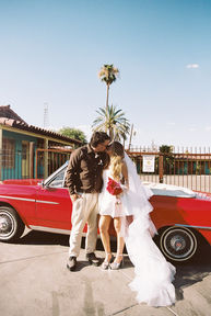 35mm film photo by las vegas elopement photographer brazen honey films. couple takes pictures with cherry red vintage convertible