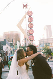 35mm film photo by las vegas elopement photographer brazen honey films. couple takes pictures in downtown las vegas with neon lights and vintage vibes.