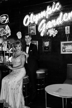 Bride and groom share a drink in a grungy dive bar in downtown las vegas on their wedding day. Captured by las vegas elopement photographer brazen honey films