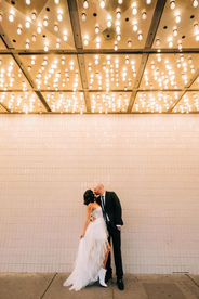 Bride and groom kiss under the neon lights in downtown las vegas, captured by las vegas wedding photographer brazen honey films