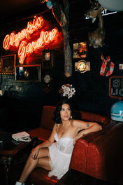 bride and groom pose for photos at a dive bar in las vegas captured by las vegas elopement photographer brazen honey films