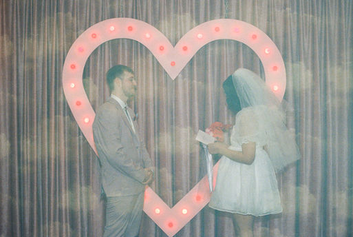 Las vegas elopement film photographer captures weddings on 35mm film. Vegas kitsch wedding vibes at the sure thing chapel. Analog photobooth in downtown las vegas.
