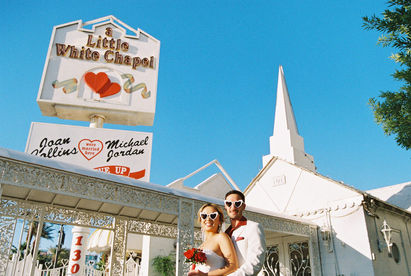 Kitsch elopement at the little white wedding chapel in las vegas shot on 35mm film. Neon lights wedding portraits by wedding photographers brazen honey films