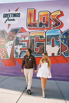35mm film photo by las vegas elopement photographer brazen honey films. couple takes pictures in downtown las vegas with neon lights and vintage vibes.