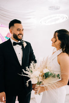 Bride and groom smile at each other during their wedding ceremony at the little white wedding chapel. Captured by las Vegas elopement photographer brazen honey films.