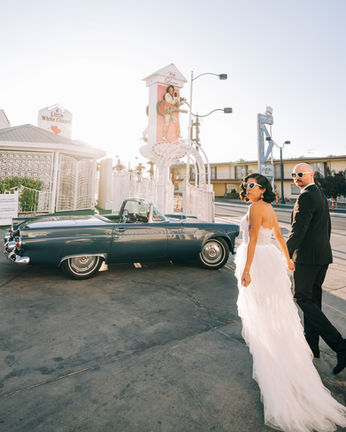 Couple celebrates their wedding outside the little white wedding chapel on fremont street. captured by las vegas elopement photographer brazen honey films
