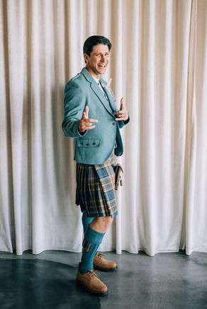 Groom poses for photos at the sure thing chapel wearing traditional scottish kilt. Groom stands at the altar at the sure thing chapel waiting for his bride. Captured by las vegas elopement photographer brazen honey films