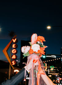 Las Vegas wedding photographer brazen honey films captures an epic elopement at sure thing chapel with elvis officiant. Photoshoot at the neon museum and downtown las vegas with neon lights.