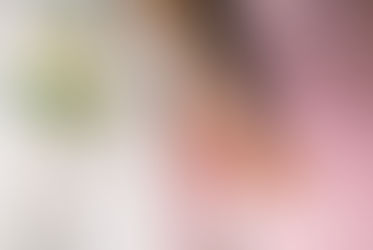 photo of hands with wedding rings sitting on a pink cadillac with white flowers
