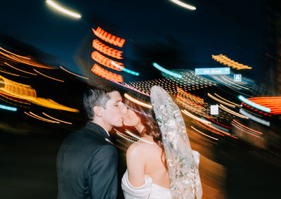 Las Vegas wedding photographer brazen honey films captures an epic elopement at sure thing chapel with elvis officiant. Photoshoot at the neon museum and downtown las vegas with neon lights. 