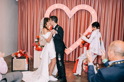 Las Vegas wedding photographer brazen honey films captures an epic elopement at sure thing chapel with elvis officiant. Photoshoot at the neon museum and downtown las vegas with neon lights.