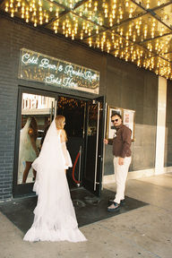 35mm film photo by las vegas elopement photographer brazen honey films. couple takes pictures in downtown las vegas with neon lights and vintage vibes.