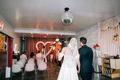 Las Vegas wedding photographer brazen honey films captures an epic elopement at sure thing chapel with elvis officiant. Photoshoot at the neon museum and downtown las vegas with neon lights. 