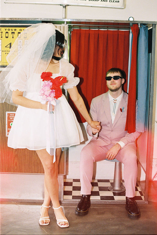 Las vegas elopement film photographer captures weddings on 35mm film. Vegas kitsch wedding vibes at the sure thing chapel. Analog photobooth in downtown las vegas.