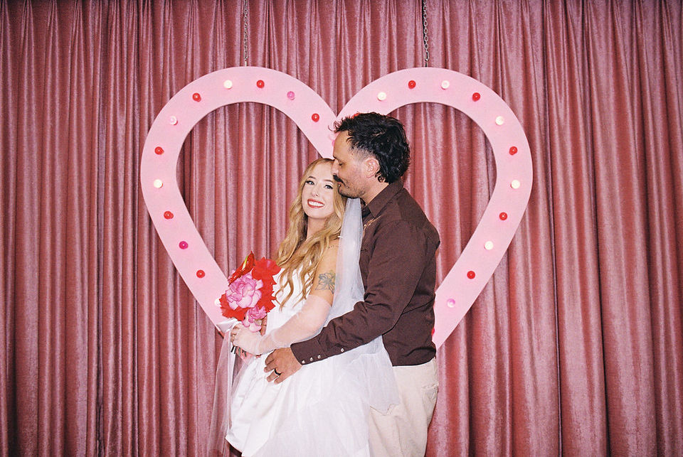 35mm film photo by las vegas elopement photographer brazen honey films. couple gets married at sure thing chapel with pink vintage vibes.