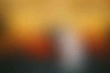 couple wearing wedding attire sitting in a red convertible underneath neon lights in las vegas