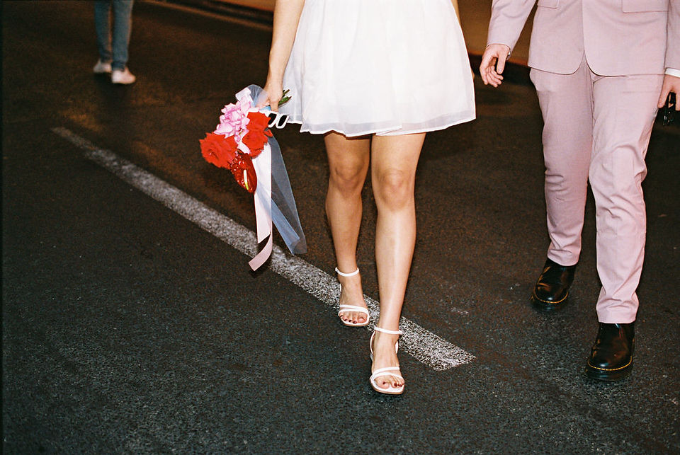 Las vegas elopement film photographer captures weddings on 35mm film. Vegas kitsch wedding vibes at the sure thing chapel. Analog photobooth in downtown las vegas.