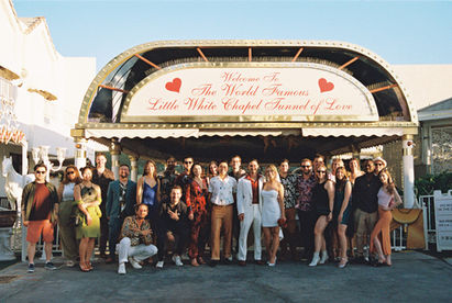 Kitsch elopement at the little white wedding chapel in las vegas shot on 35mm film. Neon lights wedding portraits by wedding photographers brazen honey films