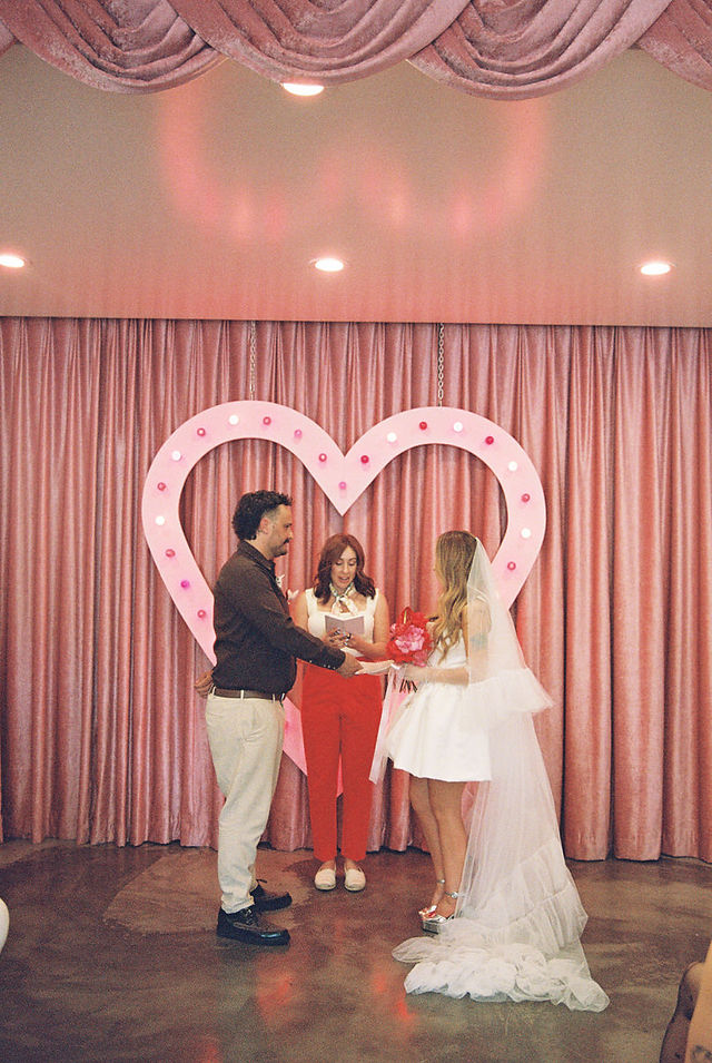 35mm film photo by las vegas elopement photographer brazen honey films. couple gets married at sure thing chapel with pink vintage vibes.