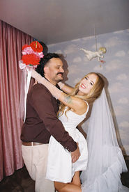 35mm film photo by las vegas elopement photographer brazen honey films. couple gets married at sure thing chapel with pink vintage vibes.