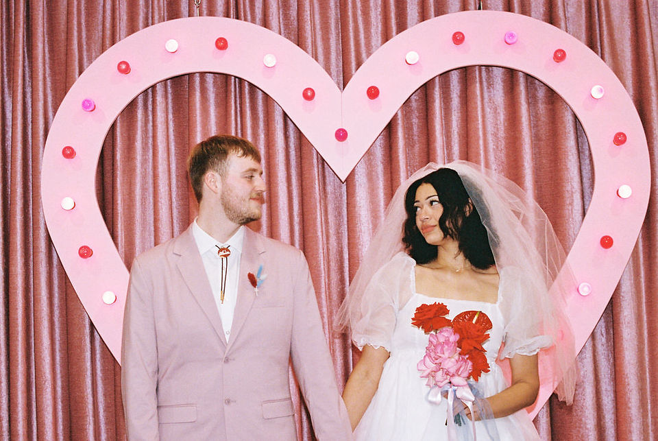 Las vegas elopement film photographer captures weddings on 35mm film. Vegas kitsch wedding vibes at the sure thing chapel. Analog photobooth in downtown las vegas.