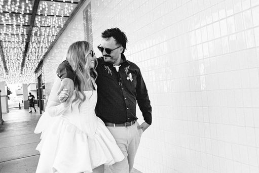 35mm film photo by las vegas elopement photographer brazen honey films. couple takes pictures in downtown las vegas with neon lights and vintage vibes.