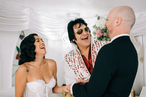 bride and groom recite wedding vows at the little white wedding chapel in las vegas. elvis wedding officiant captured by las vegas elopement photographer brazen honey films